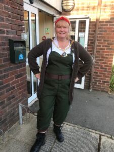 The Mayor of Peacehaven dressed in a khaki green war time land girl outfit with a red headband at the Peacehaven Players show on 10th June 2022