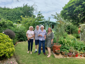 Mayor Lucy standing with residents in their garden for Peacehaven's open garden event